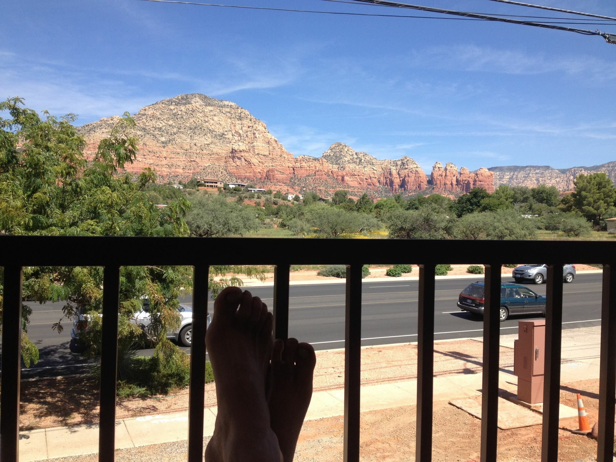 Red Rock Suites — feet up on the balcony, Sedona red rocks in the distance