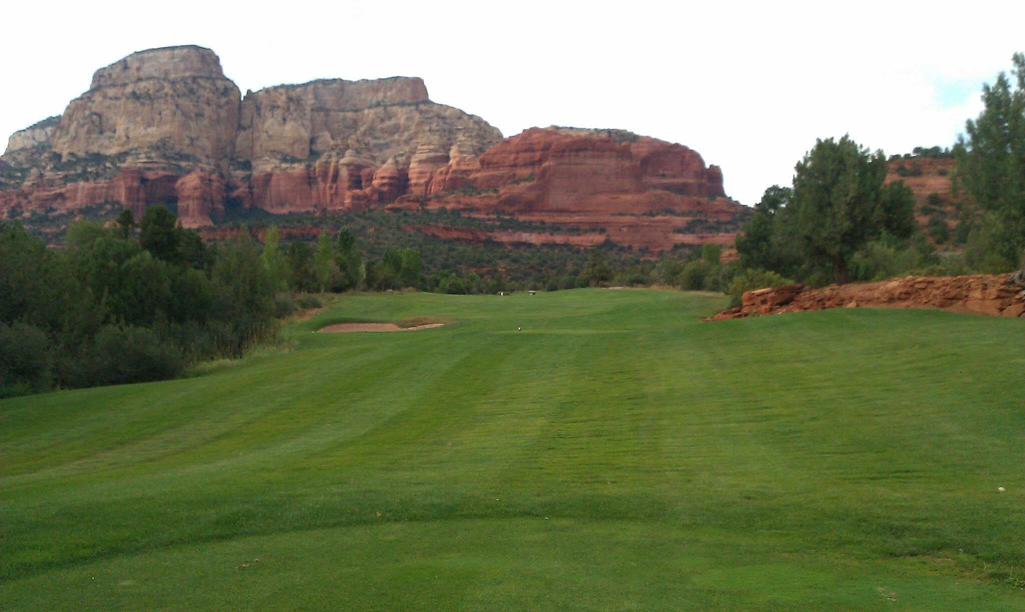 Sedona red rock cliffs above a fairway — view from near Red Rock Suites